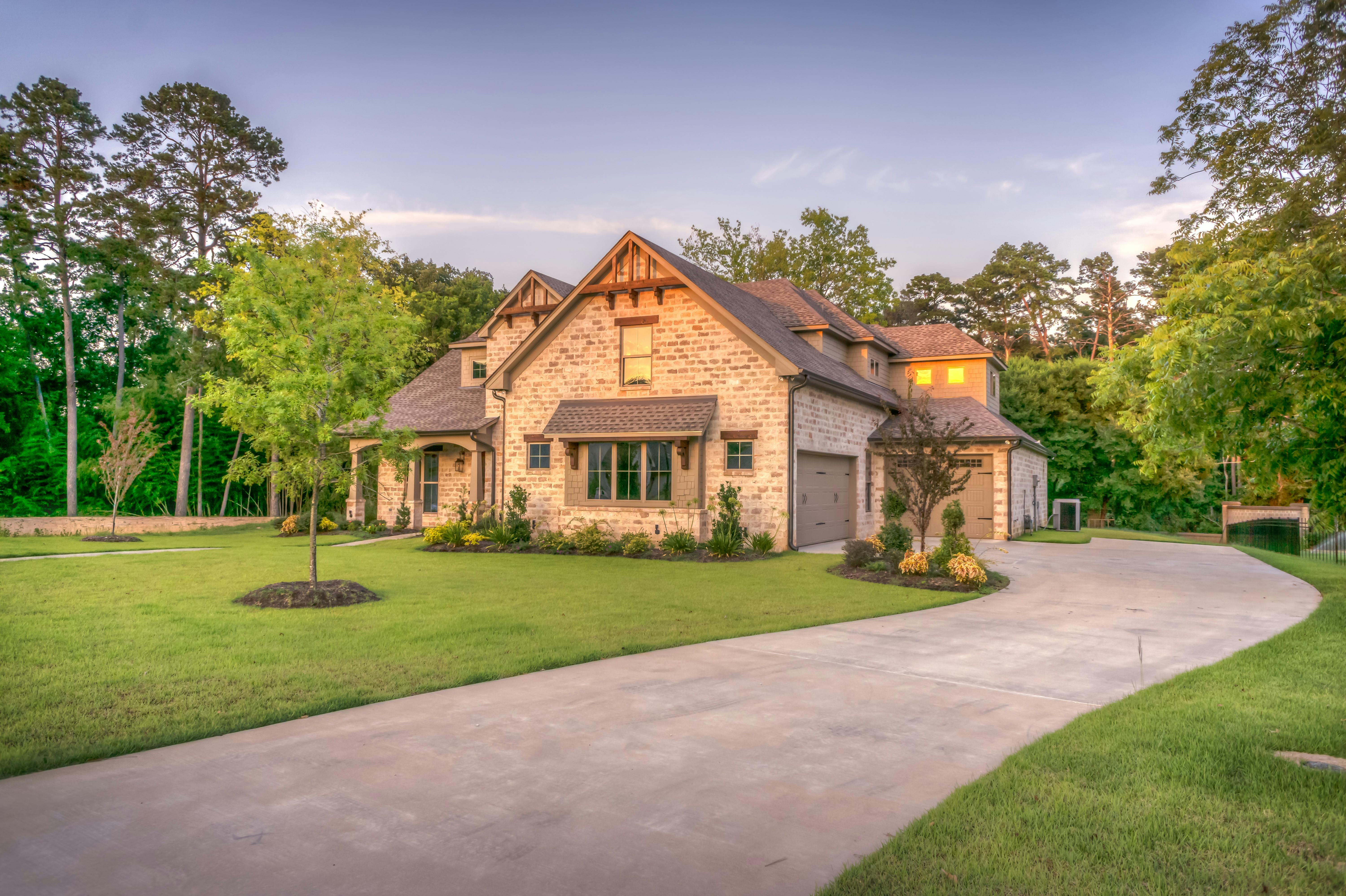 Beautiful residential property with professional landscaping and curved driveway